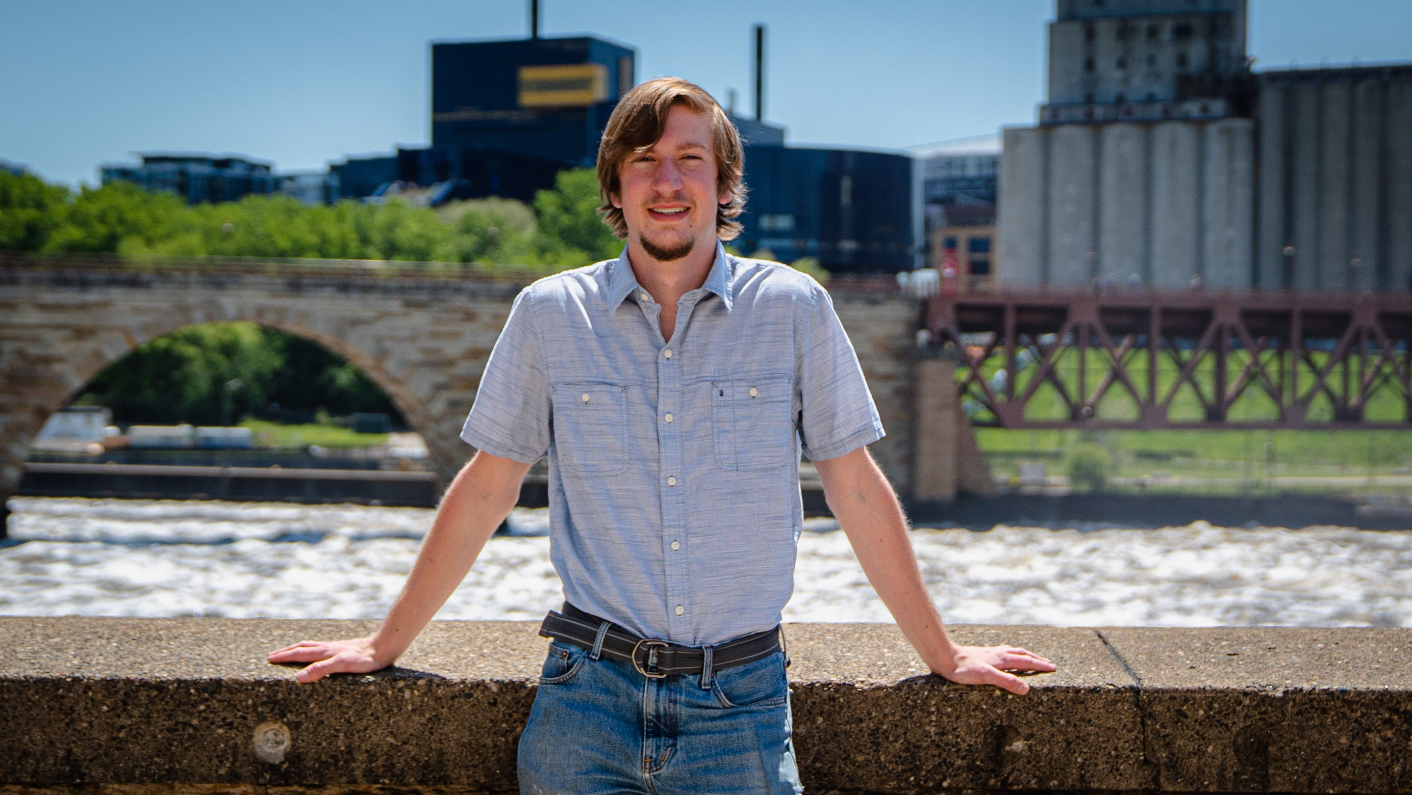 Tommy in front of the Stone Arch Bridge in Minneapolis